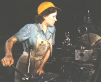 Woman working at an industrial lathe.