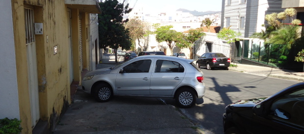 Another parked car blocking the pavement.