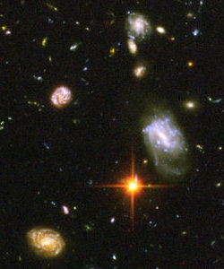 A deep field view of cosmic objects whose emitted light can be seen to be red-shifted.